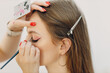 © primipil - Beautiful young woman applying makeup beauty visage brush.