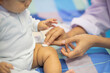 © BESTIMAGE - pediatrician Hand hold vaccine liquid injection in syringe for injecting child baby infant. small syringe needle for infant prevention flu by vaccination immunity in Pediatrics hospital clinic.