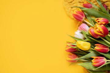 Wall Mural - 
beautiful frame mockup with tulips and cozy blanket on a bright yellow background. top view. copy space. flat lay