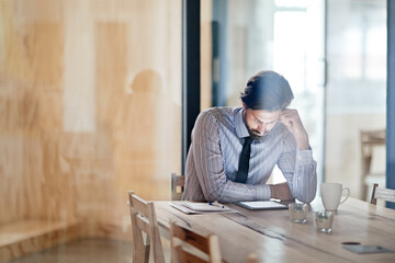 Aufkleber - Hes always the last one in the office. a young businessman using a digital tablet in an office.
