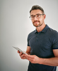 Canvas Print - You name it, theyve got an app for that. a man using a digital tablet against a gray background.