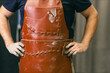 © primipil - Man sculptor dressed leather apron with clay in hands. Statue craft creation workshop.