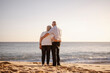© eunikas - Elderly couple hugging each other on the beach