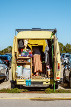 A Yellow Camper Van With Woman Owner Inside Parked On A Crowded Parking Lot In Portugal