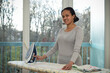 © AUFORT Jérome - mixed race woman ironing at home