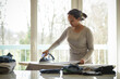 © AUFORT Jérome - mixed race woman ironing at home