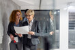© Novak - Middle aged female business mentor walking with employees in company