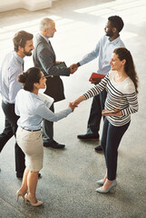 Aufkleber - meeting on the move. high angle shot of businesspeople standing in a office lobby.