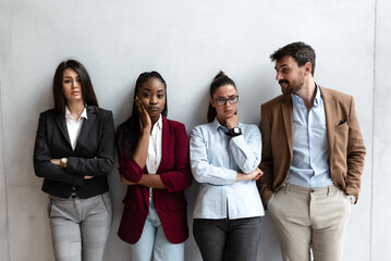 Group of young business people freelancers stand in an office waiting results of meeting Businessman and businesswomen have proposed their project to the board of directors and awaiting a decision