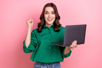 Poster - Portrait of delighted person raise fist hold netbook achievement luck isolated on pink color background