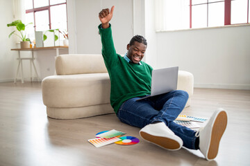 Wall Mural - Joyful Black Male Freelancer Using Laptop Gesturing Yes At Home