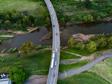 Aerial View Of Semi Truck And Cars Driving Over Bridge Crossing Hunter River