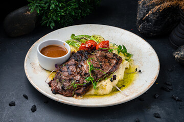 Canvas Print - Ribeye beef steak with mashed potatoes and sauce in a plate.