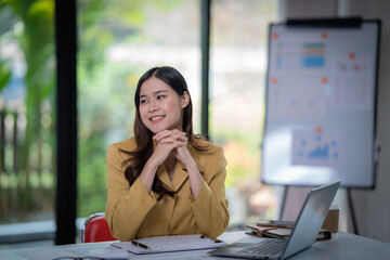 Happy businesswomen siting in the office and smiling analyzing weekly schedule in the office