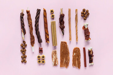 Dog dry snack collection. Different types of food. Organic natural training treat. Light pink background.