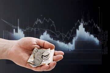 Sticker - Crumpled money note with falling down digital  trading chart.