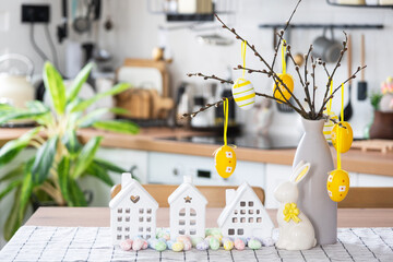 key to house of cozy home with easter decor with rabbit and eggs on table of kitchen. building, desi