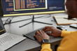 © Seventyfour - Close up of unrecognizable black man typing at keyboard while writing code in IT development company, copy space
