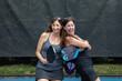 Two pickleball players posing with paddles