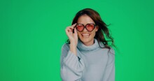 Cool, Green Screen And Portrait Of A Woman With Sunglasses Isolated On A Studio Background. Stylish, Fashionable And Girl Posing, Modeling And Wearing Fun Eyewear On A Mockup Backdrop With Space