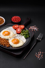 Delicious hearty breakfast consisting of two fried eggs, canned lentils and microgreens