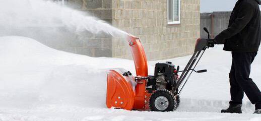 Wall Mural - A portable snow blower powered by gasoline. Snow removal in winter.