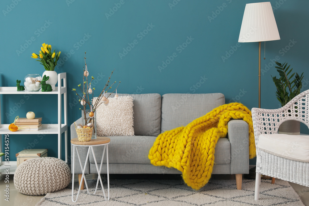 Interior of living room with sofa and Easter decor