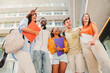 © Jose Calsina - A group of multiracial teenage students smiling and having fun together in the university campus. Happy young people standing at the college with backpacks and notebooks. Friendship concept. High