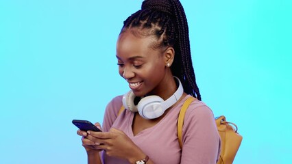 Poster - Phone, happy and black woman in a studio networking on social media, mobile app and the internet. Happiness, laugh and African female model typing a text message on a cellphone by a blue background.