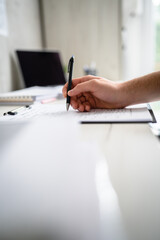 close up on hand of unknown person caucasian man hold pencil on the desk table write at work or study copy space bright photo