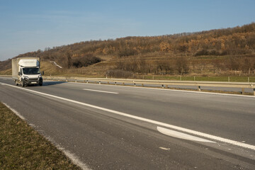 Wall Mural - Truck with container on highway, cargo transportation concept. 