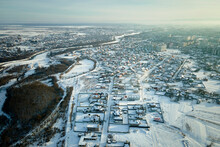 Aerial View Of Residential Houses With Snow Covered Roofops In Suburban Rural Town Area In Winter