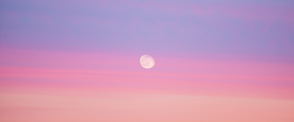 Wall Mural - beautiful backdrop of sunset sky of pink orange lilac colors and moon in center. colorful smooth daw