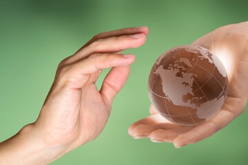 Wall Mural - Concept of Earth Day. Hands hold a Globe.