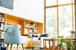© Caseyjadew - Modern bright living room featuring pastel blue chair well-lit on bright spring day