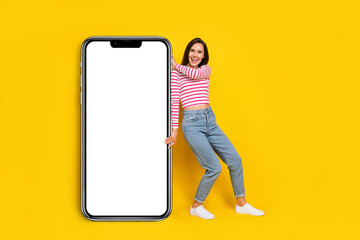 Sticker - Photo of pretty lady arm hold big modern device gadget telephone panel wall mirror empty space isolated on yellow color background