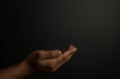 © Sinlatham - Praying hands with faith in religion and belief in God on dark background. Power of hope or love and devotion.