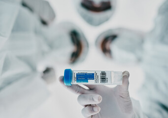 Poster - Healthcare scientists holding a vaccine, test tube and medical treatment while doing covid research in a laboratory. Group of science technicians standing together with the cure for corona virus