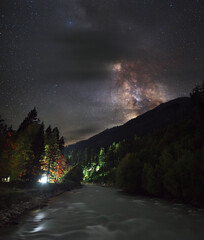 Wall Mural - night landscape. milky way over mountain river.