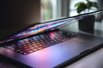 close up of laptop keyboard colorful neon illumination, backlit keyboard.