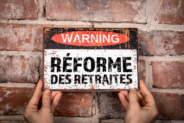 pension reform in french. warning sign with text