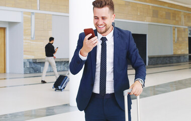 Poster - I have to save this video for later. Cropped shot of a handsome young businessman using his cellphone and showing excitement while in the office during the day.