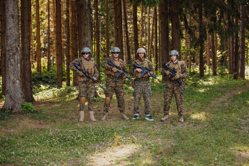 Soldier fighters standing together with guns. Group portrait of US army elite members, private military company servicemen, anti terrorist squad