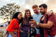 © bernardbodo - Friends using cellphone at music festival