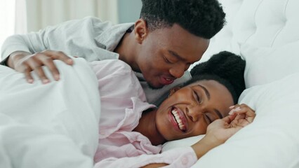 Canvas Print - Relax, couple and love in bedroom kiss, rest and comfort in happy relationship together at home. Man and woman lying in bed relaxing, talk and smile in comfortable house and morning happiness