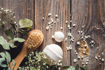 Wall Mural - Brush, bath bombs, sea salt and dried flowers, on a wooden background.