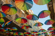 © Elena - Colorful rainbow umbrellas on Pink Street in Lisbon, Portugal, Europe