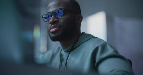 Leinwandbilder - Black Male Developer Smiling Happily After Successfully Typing on Computer a Functioning Software Code. Professional Programmer Creating a Mobile App, Screen Display Reflected on his Glasses