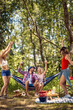 © luckybusiness - Group of young backpackers, having picnic in forest. Celebrating together, having fun. Young man and woman enjoying holiday. Holiday, togetherness, fun, lifestyle concept.