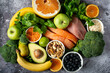 healthy foods, superfoods, meat, fish and greens on a gray background.